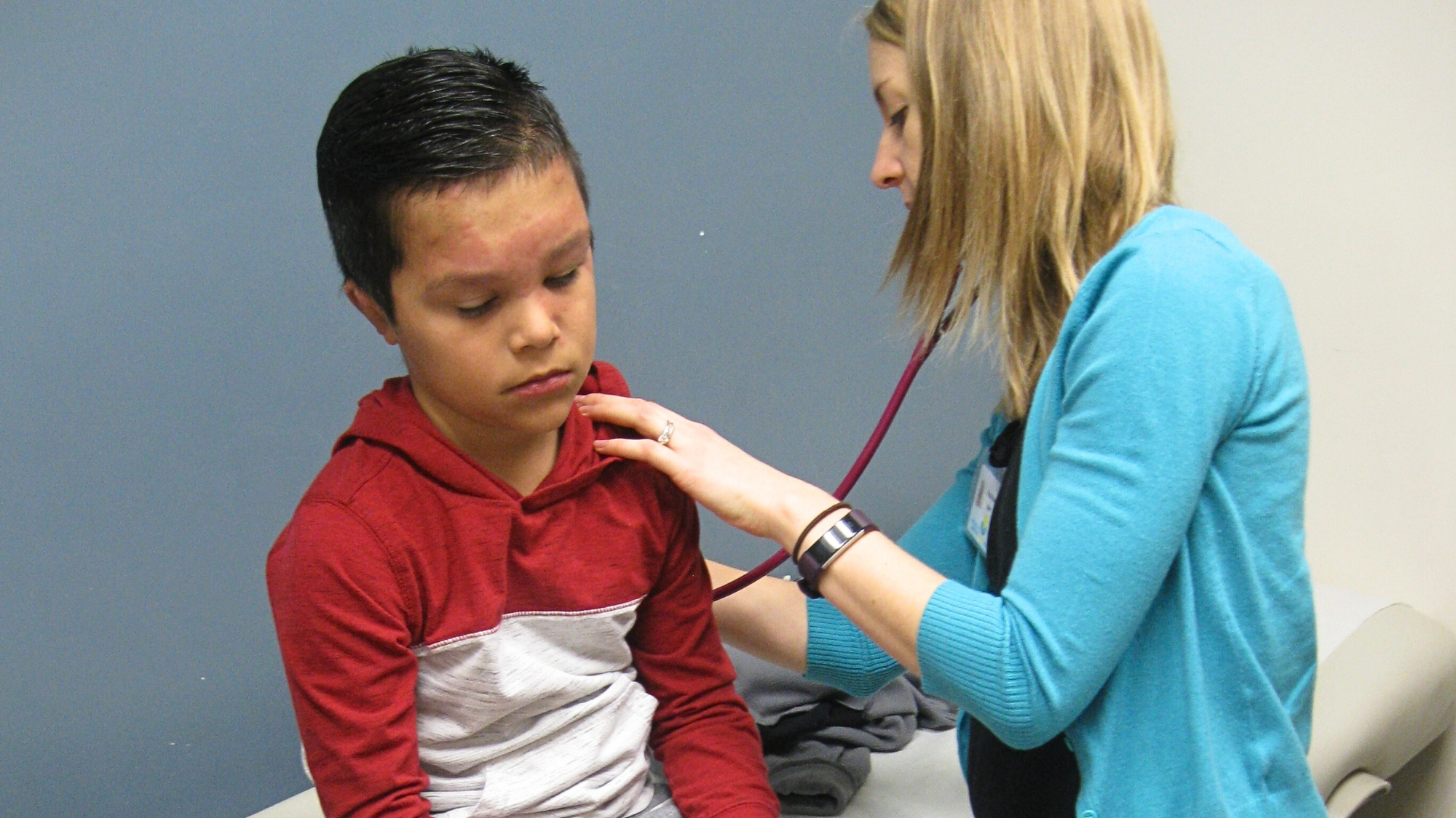 Provider with young boy at medical visit