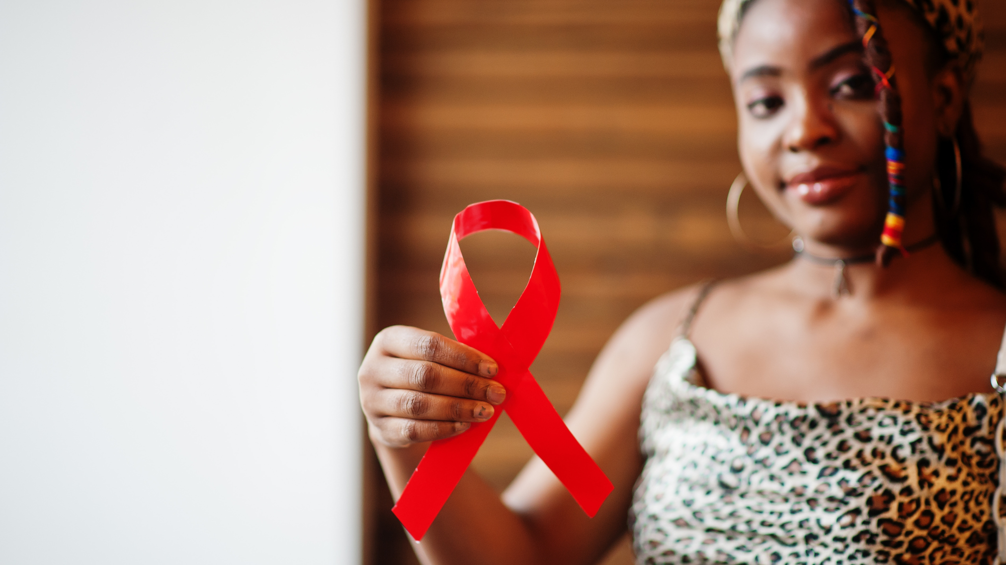 woman in background holding red ribbon