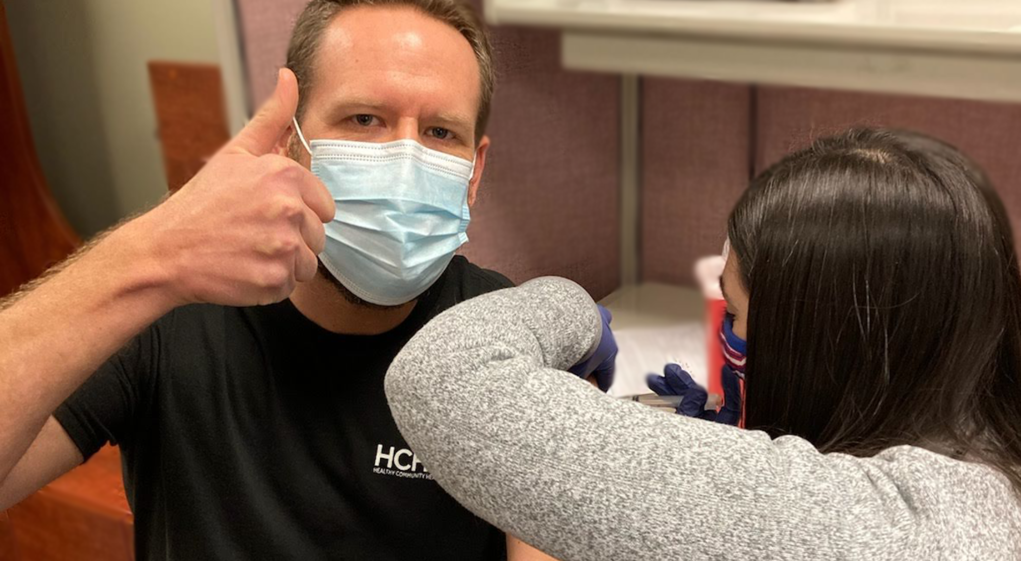 Dr. Jeff Domingus giving thumbs up getting a vaccine